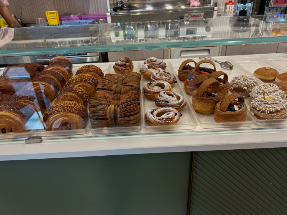 An authentic Italian bar counter filled with freshly baked breakfast pastries