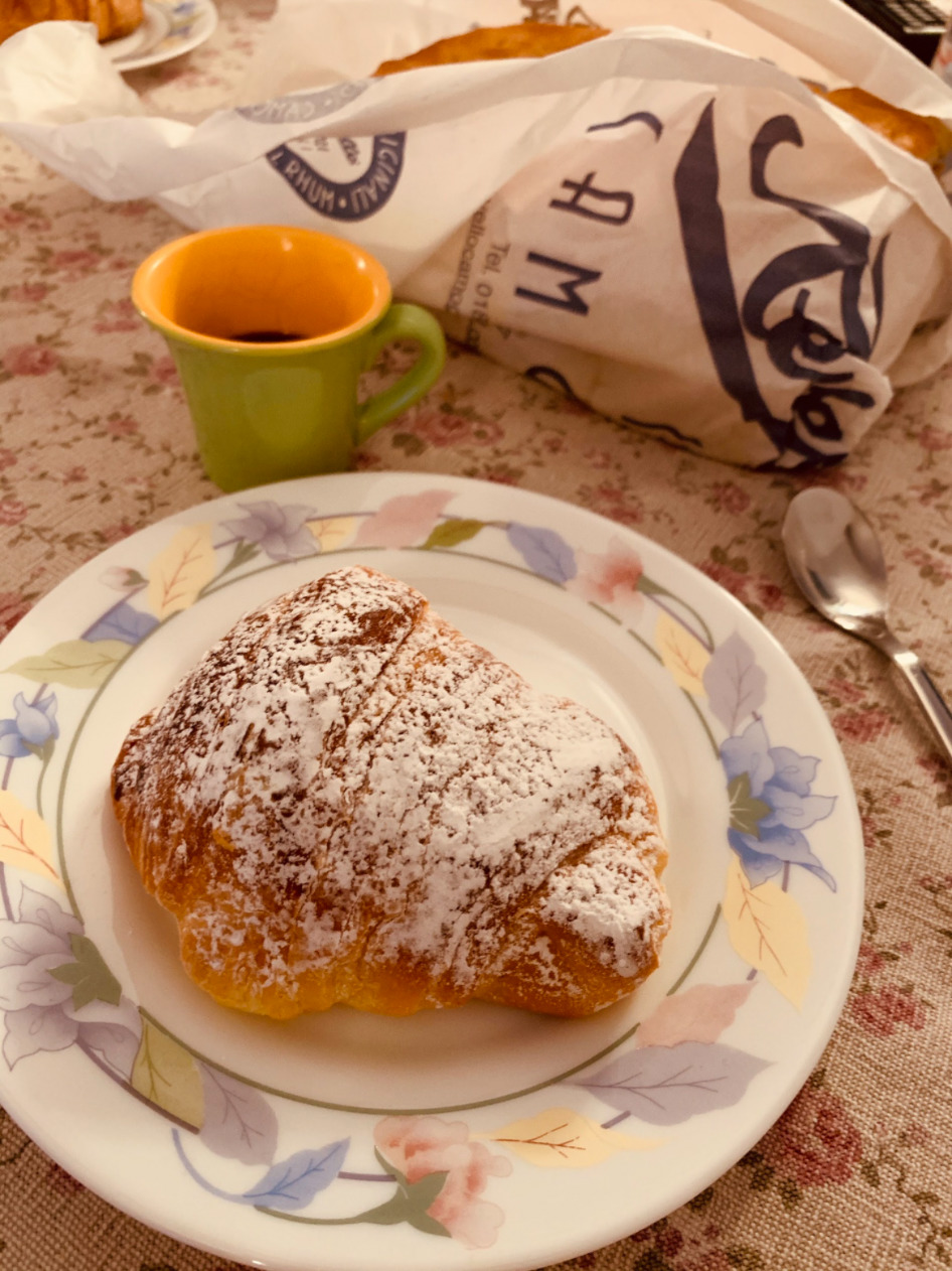 An authentic Italian breakfast with a cornetto and espresso
